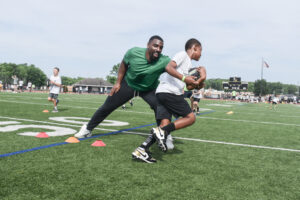 Philadelphia Eagles defensive tackle Thomas Booker IV running a ball handling drill at Eagles Youth Football Academy