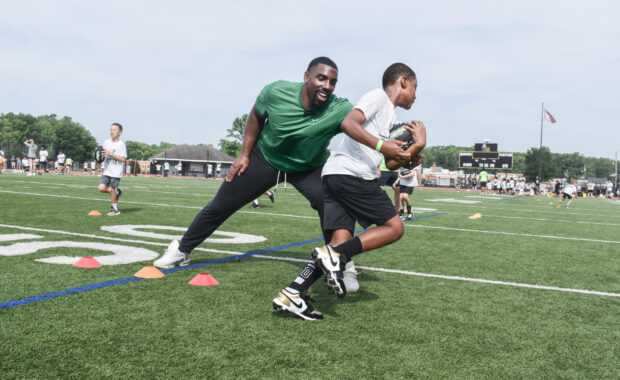 Philadelphia Eagles defensive tackle Thomas Booker IV running a ball handling drill at Eagles Youth Football Academy