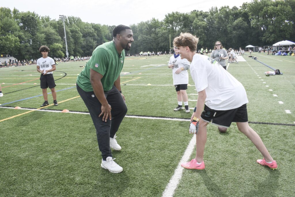 Philadelphia Eagles defensive tackle Thomas Booker IV running a ball handling/defensive drill at Eagles Youth Football Academy